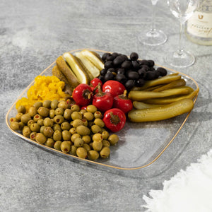 clear serving tray with gold rim loaded with food for display