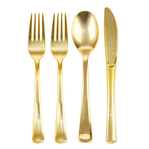 a set of disposable gold glitter flatware with white background