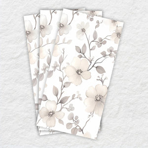 Set of three floral-patterned napkins on a textured surface
