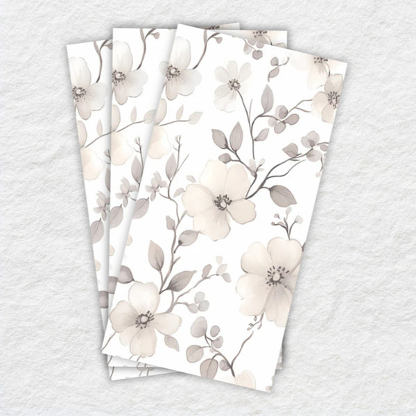 Set of three floral-patterned napkins on a textured surface