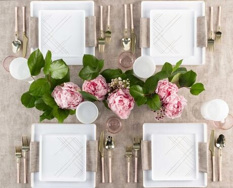 Multiple White and gold geometric design square plastic dinnerware set arranged on a table