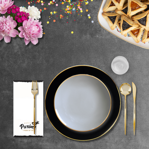 Elegant table setting with black plates, gold cutlery, and flowers on a dark surface.