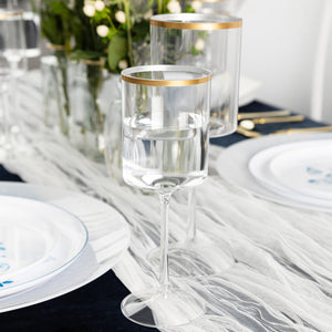 clear and gold plastic wine glasses arranged on a table