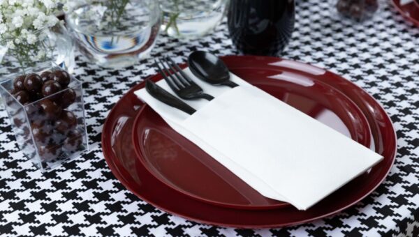 red plates on a black and white tablescape
