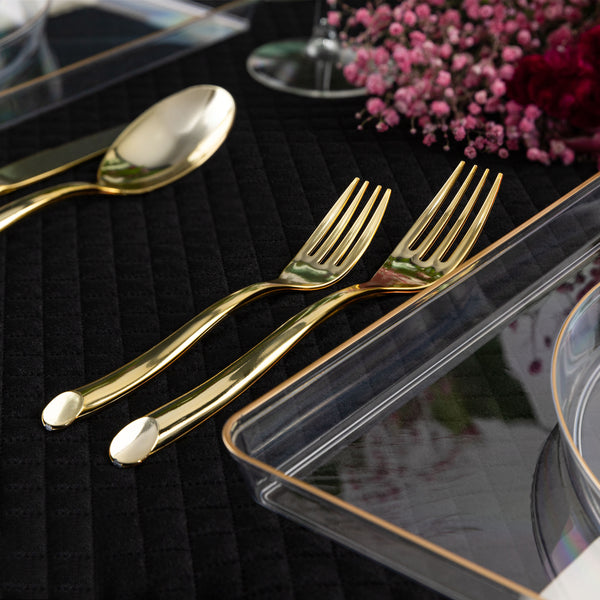 gold plastic flatware in a place setting on a tablescape