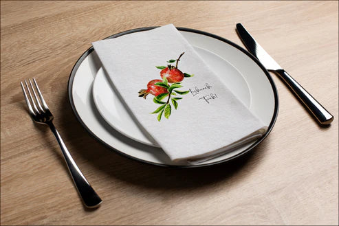 place setting with disposable napkin with shana tova pomegranate design 