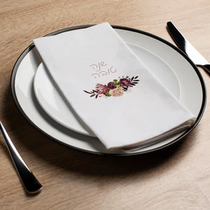 place setting with disposable napkin with shana tova floral design 