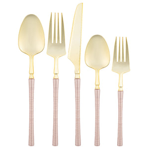 pink and gold plastic flatware set on white background