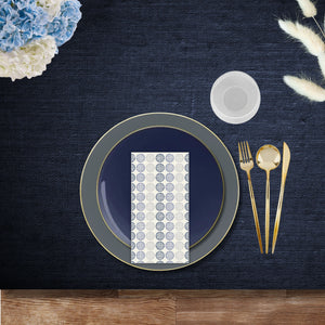 Slate gray and navy disposable dinnerware place setting with gold cutlery, ribbed stemless goblet, and Blue Circles linen-like napkin.