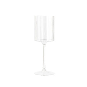 Clear glass wine glass with vertical ribbing on a white background