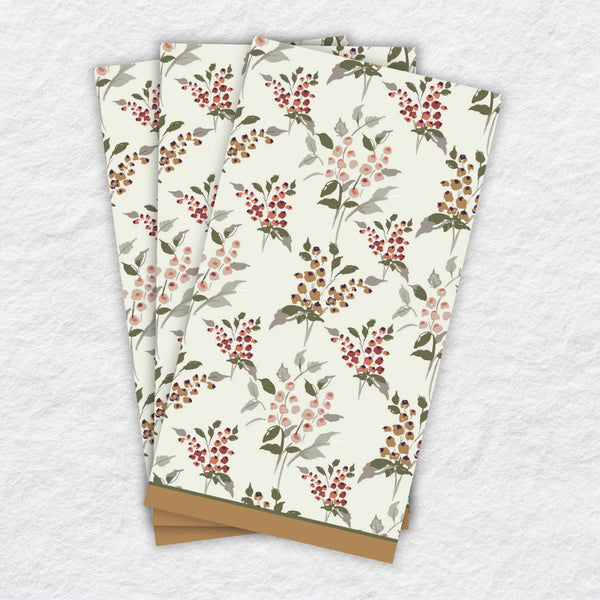 Three paper napkins with floral pattern on a textured surface