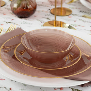 rose and gold soup bowl on a tablescape with matching plates