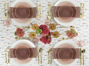tablescape with setting of rose with gold rim plastic dinner and salad plate 
