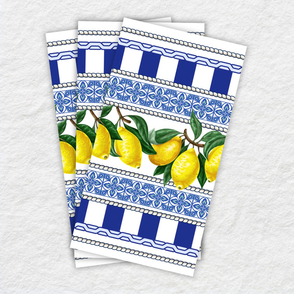 Set of three decorative paper napkins with lemon and blue pattern design on a textured white background