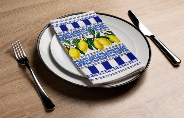Napkin with lemon design on a plate with cutlery on a wooden table