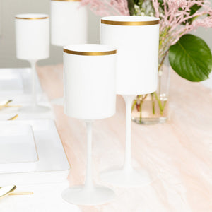 white and gold plastic wine glasses arranged on a table