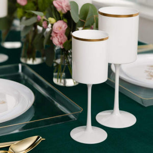 white and gold plastic wine glasses arranged on a table