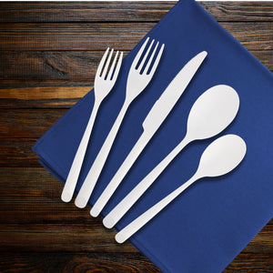 white plastic flatware set on a wooden table